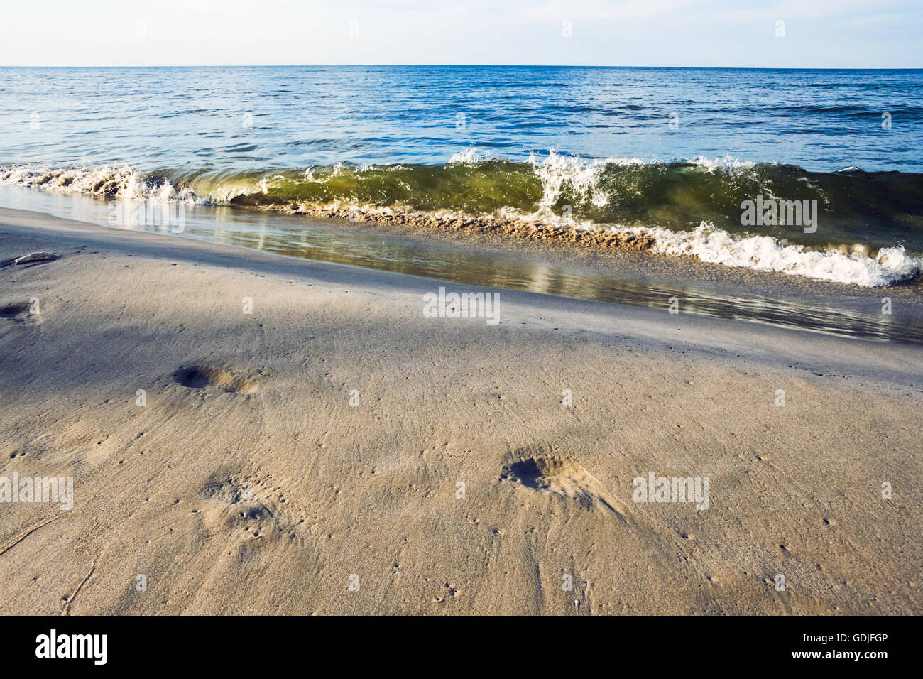 Sea sand footsteps and waves Stock Photo
