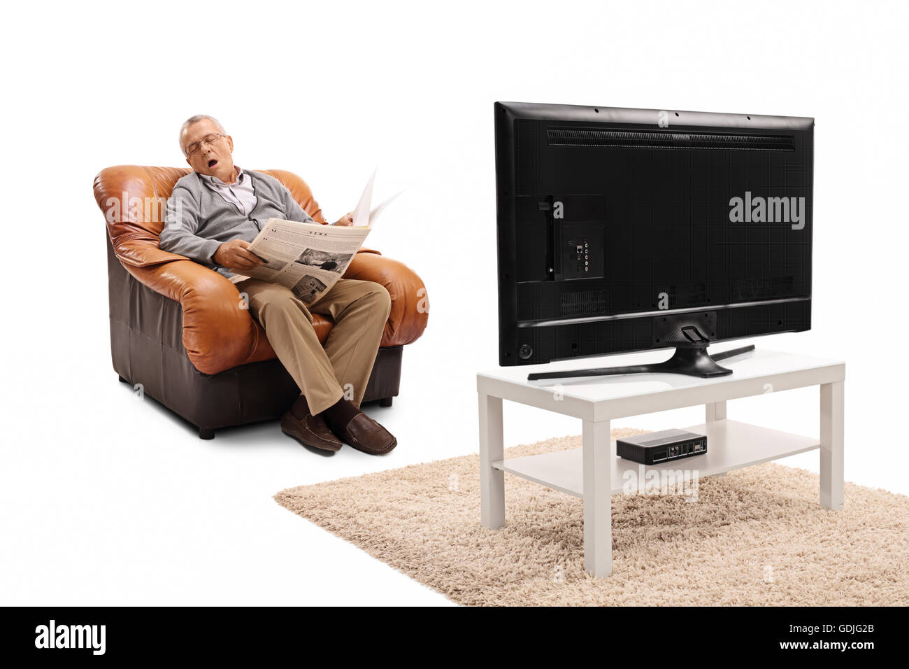 senior-man-holding-a-newspaper-and-sleeping-in-front-of-the-tv-isolated-GDJG2B.jpg