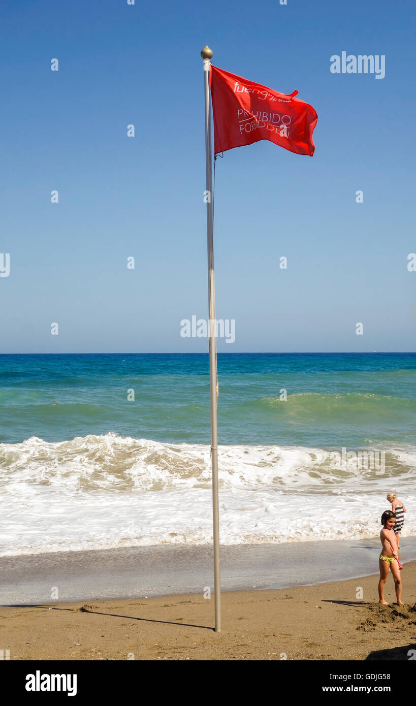 Red flag beach warning, no bathing, on Spanish beach, Fuengirola, Andalusia, Spain. Stock Photo