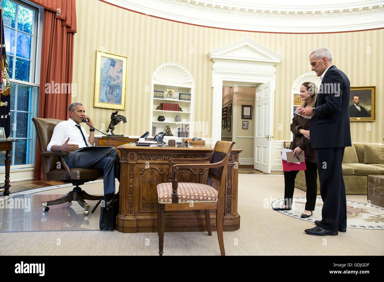 U.S President Barack Obama talks on the phone from the Oval Office with Secretary of State John Kerry regarding the coup attempt in Turkey as Chief of Staff Denis McDonough and Avril Haines, Deputy National Security Advisor, listen July 15, 2016 in Washington, DC. Stock Photo
