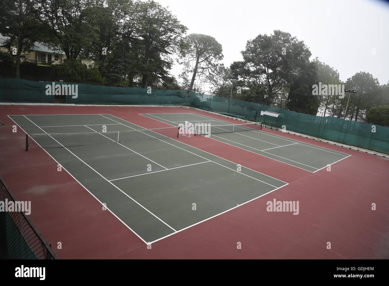 Empty Closed tennis court sport play ground locked all weather surfaced tennis courts, India, Asia Stock Photo