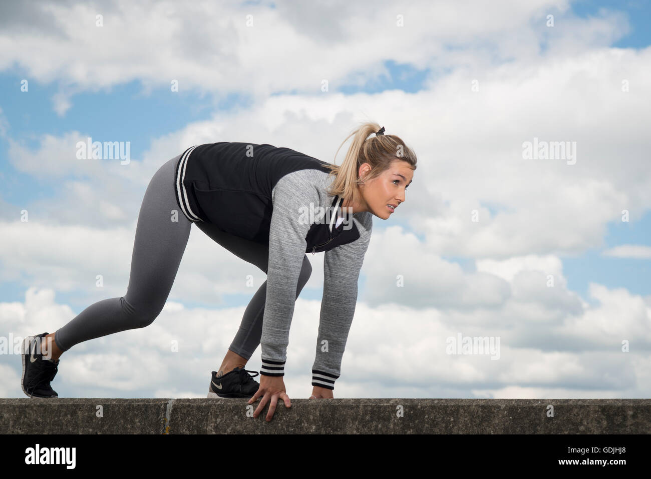 woman getting ready to run, outdoors Stock Photo - Alamy
