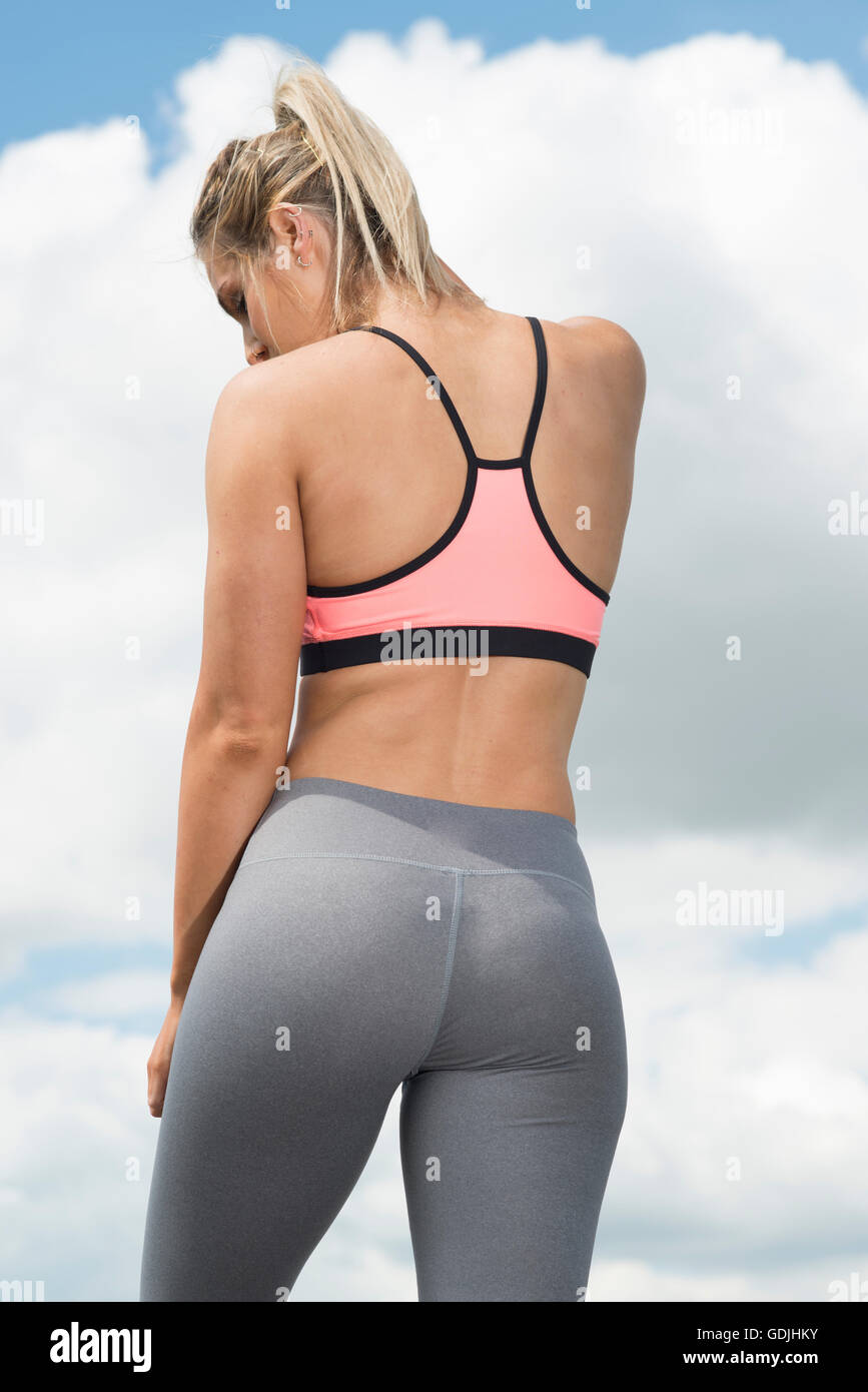 fit woman wearing sports bra and leggings from behind Stock Photo