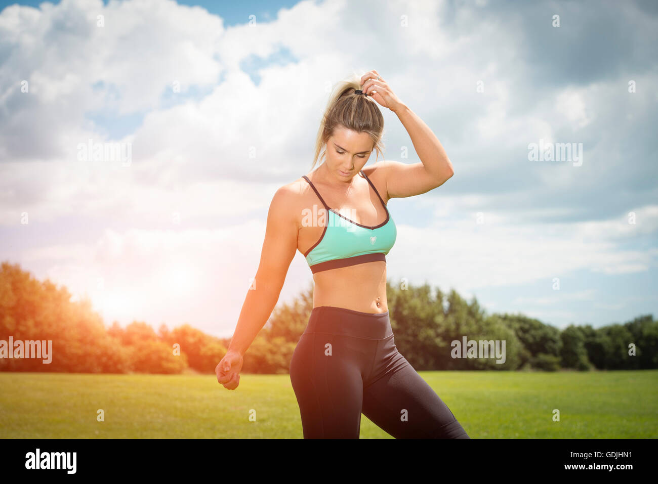 fit woman wearing sports bra and leggings keeping fit Stock Photo