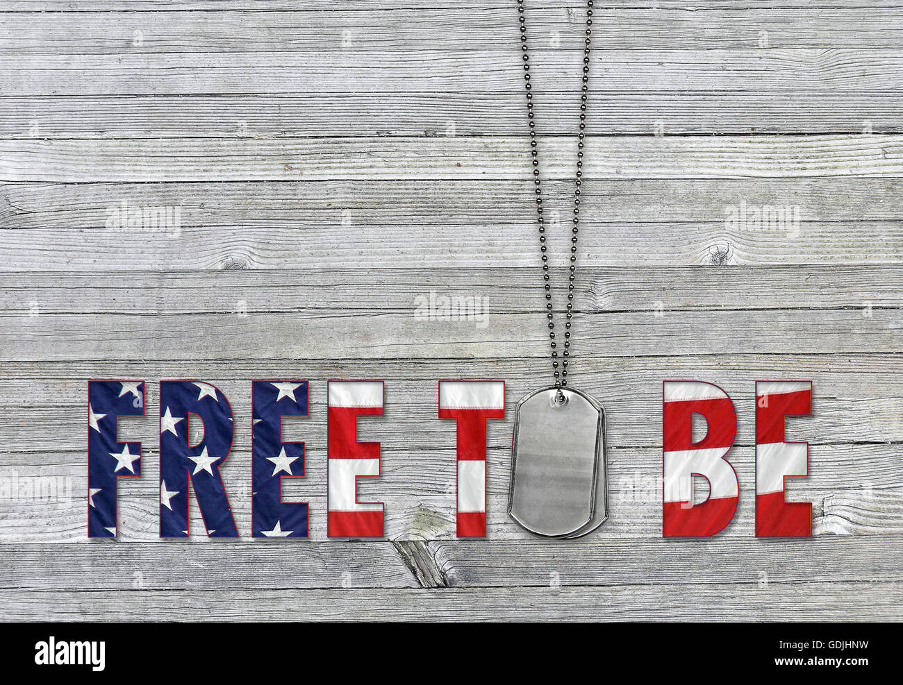 Military dog tags and inspirational quote with American flag pattern on weathered gray wood. Stock Photo