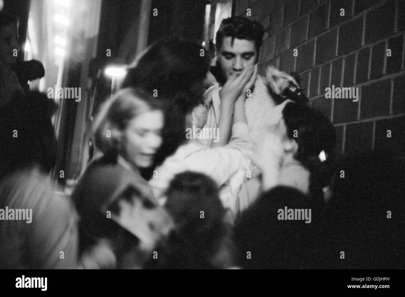 Elvis Presley mobbed by fans after a performance at the University of Dayton Fieldhouse, May 27, 1956. Stock Photo