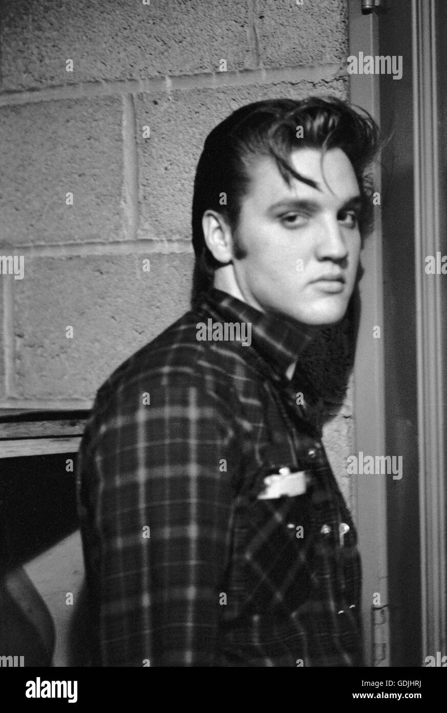 Elvis Presley, between performances, backstage at the University of Dayton Fieldhouse, May 27, 1956. Stock Photo