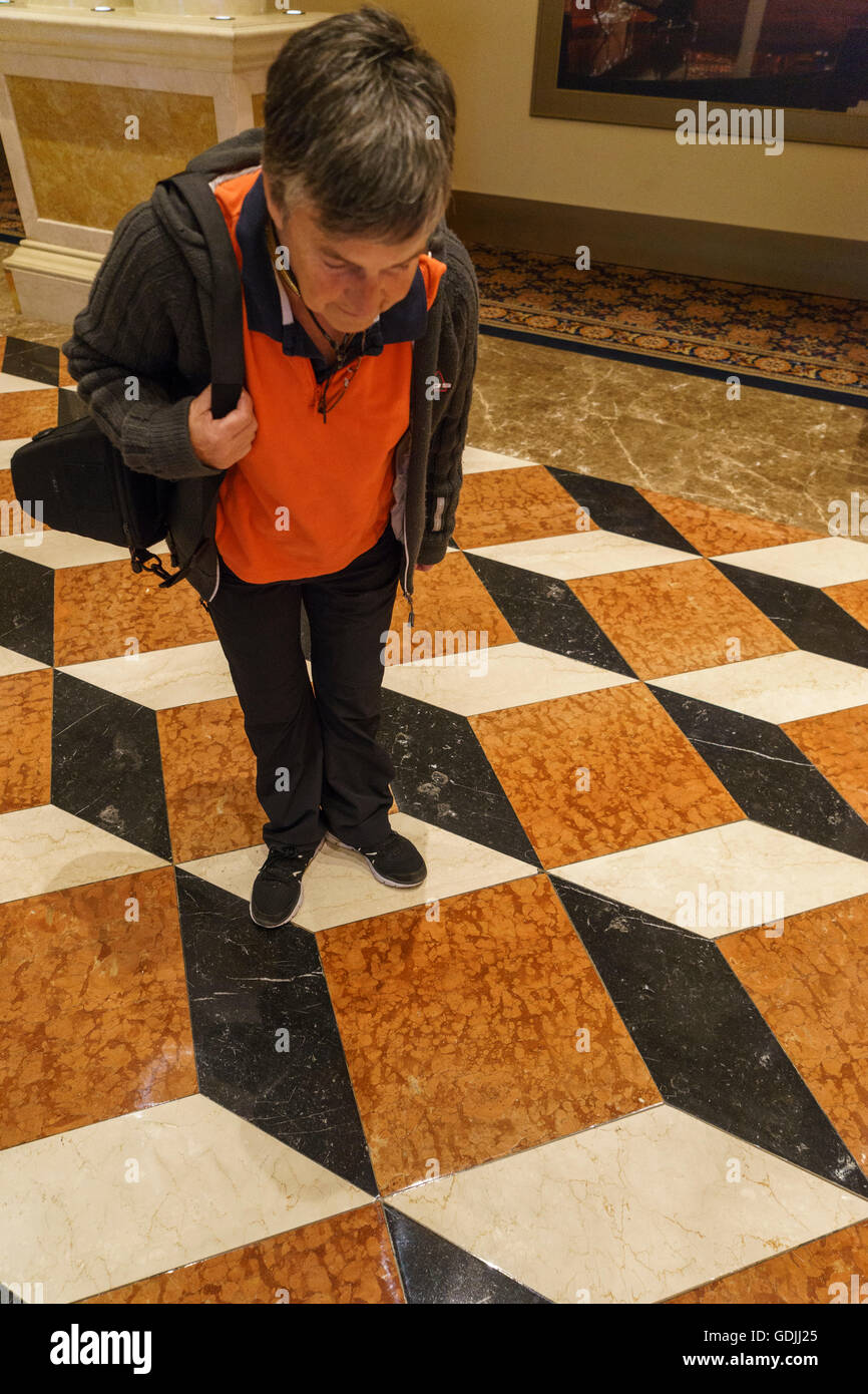 Female looking down at the optical illusion of the flooring in the Venetian Hotel Las Vegas Stock Photo