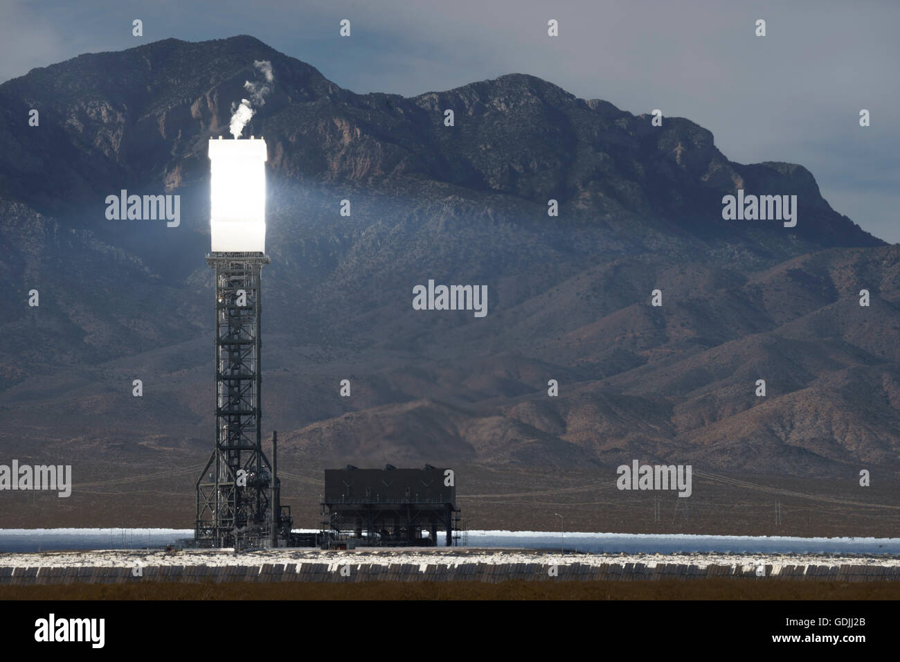 One of the towers of the Ivanpah Solar Electric Generating System  in the Mojave Desert California brightly lit by sunlight Stock Photo