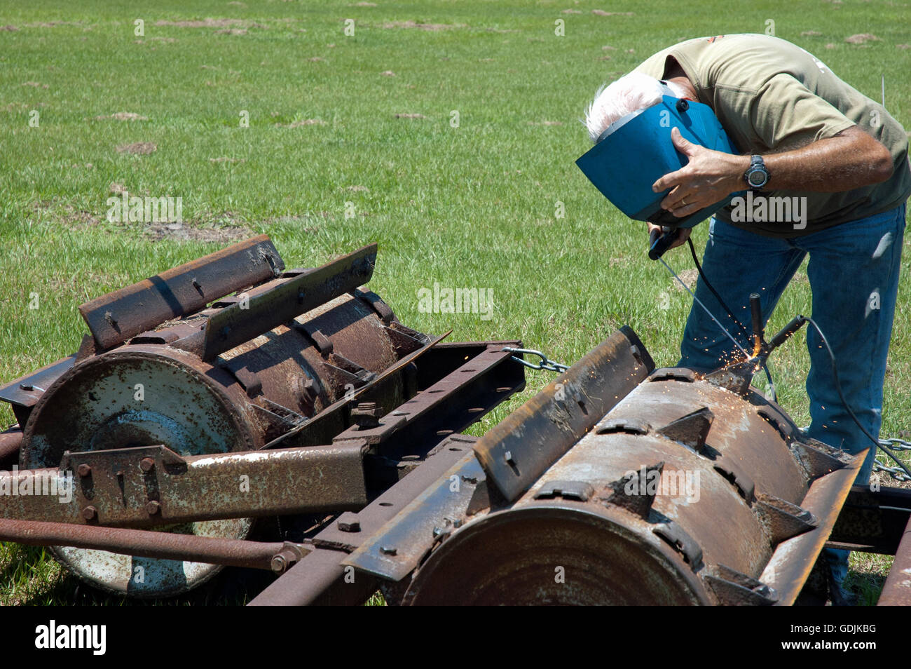 Central Florida Rancher Welding a Drum Soil Aerator Stock Photo