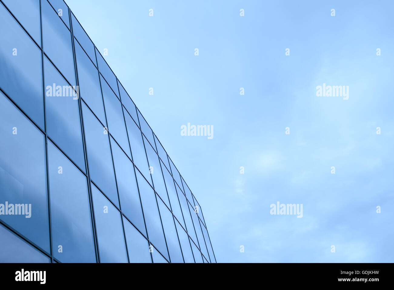Business office building exterior with glass windows on cloudy day Stock Photo