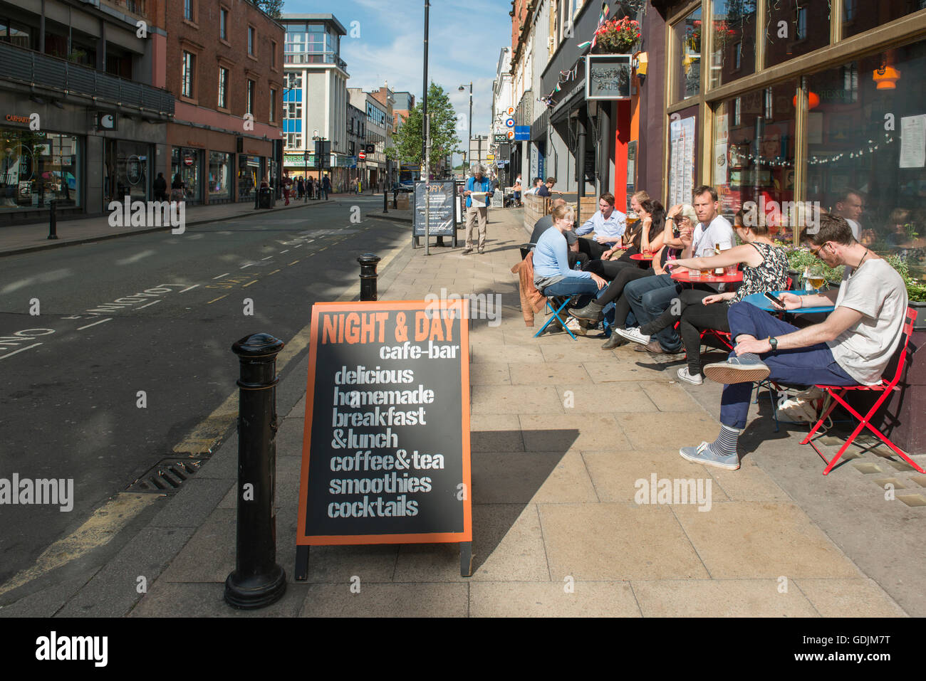 People enjoying a drink outside Night and Day cafe on Oldham Street in the Northern Quarter area of Manchester. Stock Photo