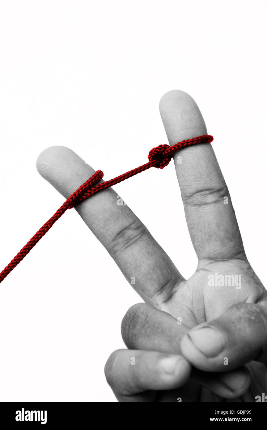 Two fingers being tied together by a rope to represent the unity. Stock Photo
