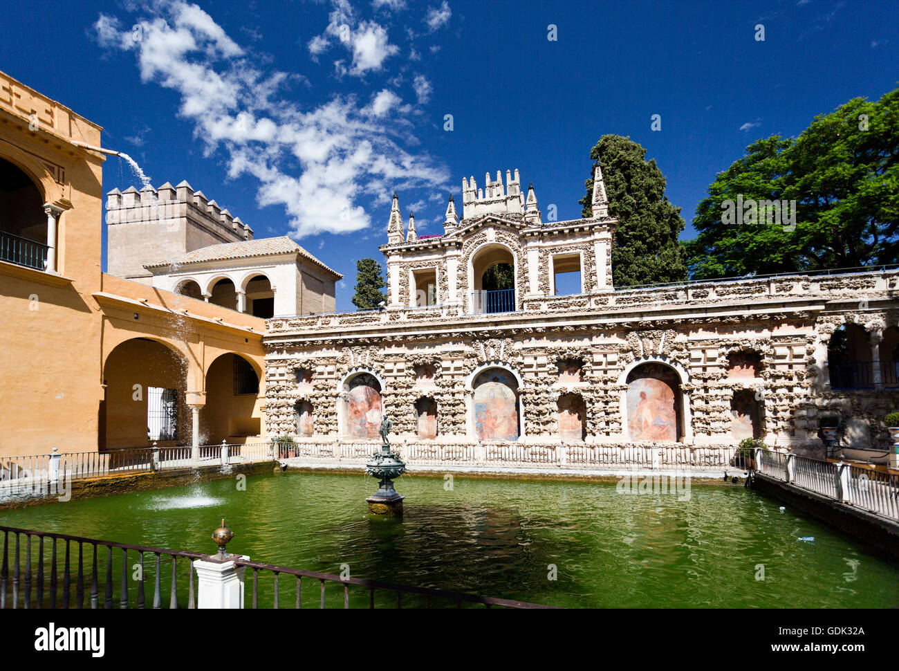 View of the pool and Grotto Gallery (Galeria de Grutesco) in the gardens of the Alcazar of Seville, Spain Stock Photo