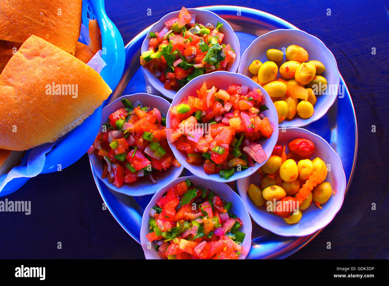Moroccan salad, with tomatoes, onions, green pepper fruits and fresh coriander, and preserved green olives, Morocco. Stock Photo