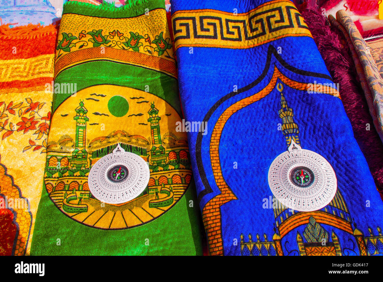 Praying carpets with a compass, to give the direction of the Holy Mecca