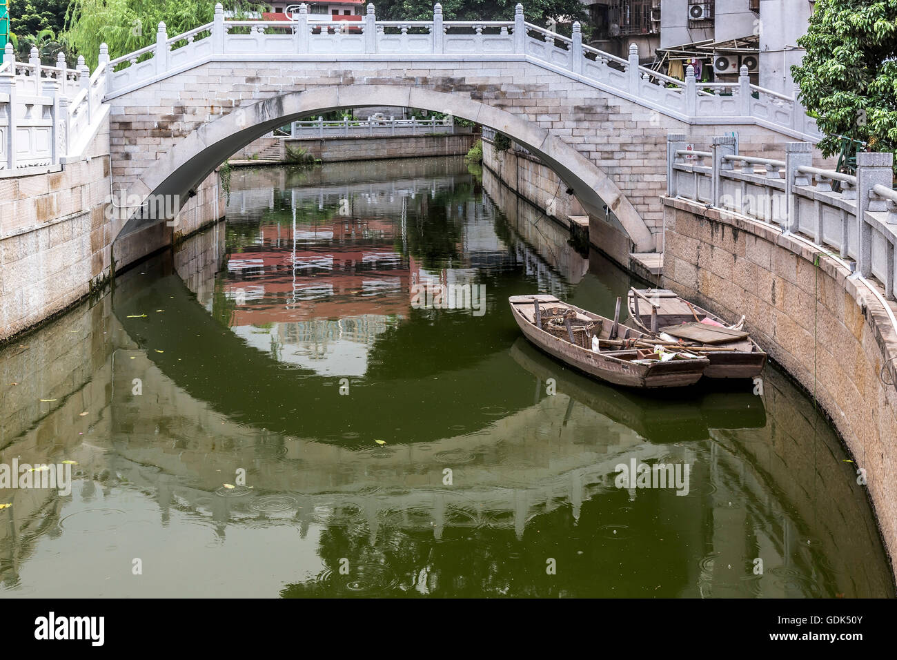 Little boats and bridge on the canals of Liwan Park in Guangzhou, China Stock Photo