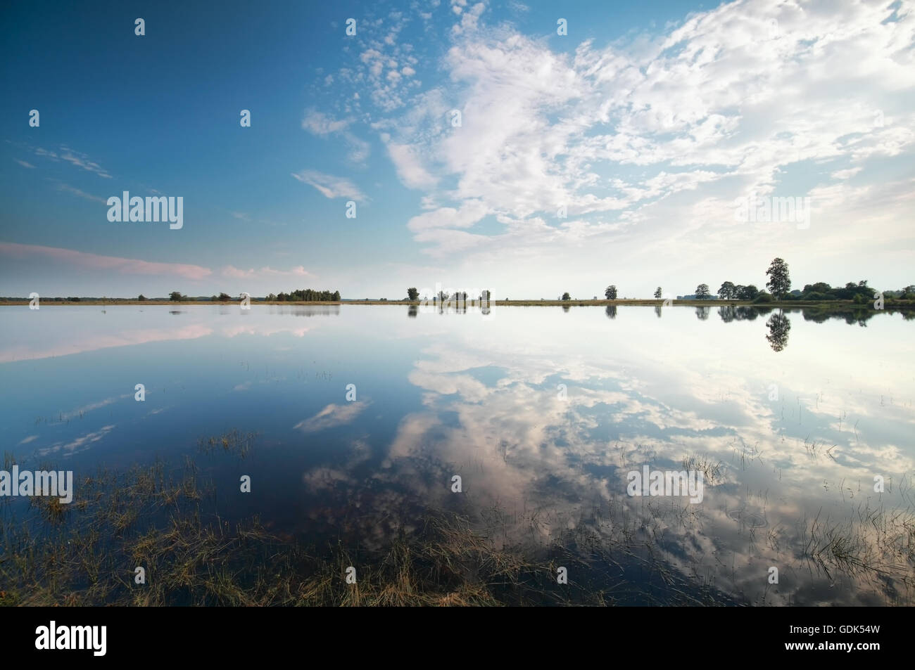 blue sky with white clouds reflected in lake Stock Photo - Alamy