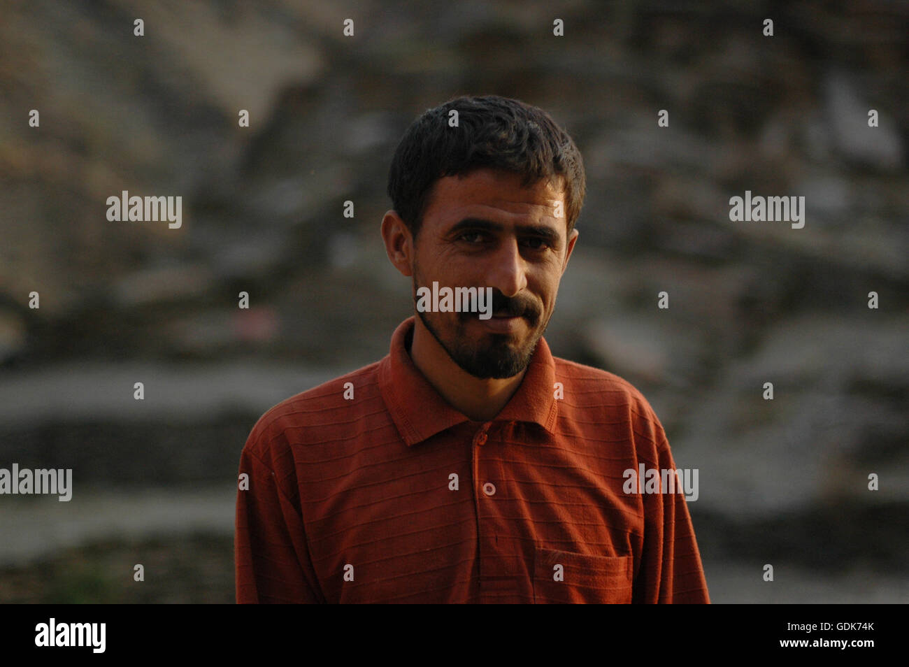 Ahmad, a laborer working on a farm in Al-Yann Wadi 4 hours outside of Abha. Ahmad crossed the border from Yemen illegally and will move from farm to farm over the next few years before leaving back to Yemen. Stock Photo