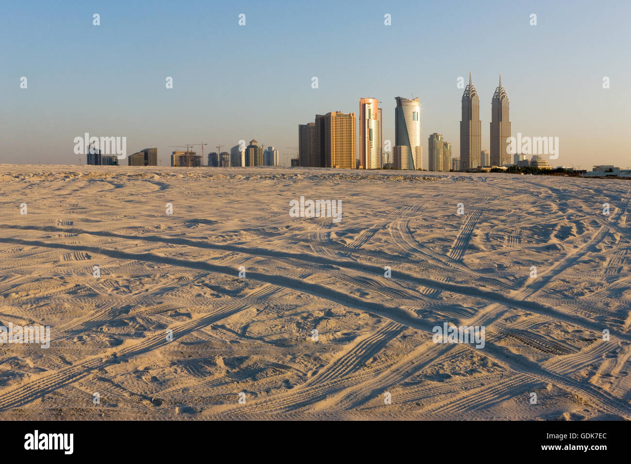 Car tracks on the sand near Sheikh Zayed Road at Dubai, United Arab Emirates. Stock Photo
