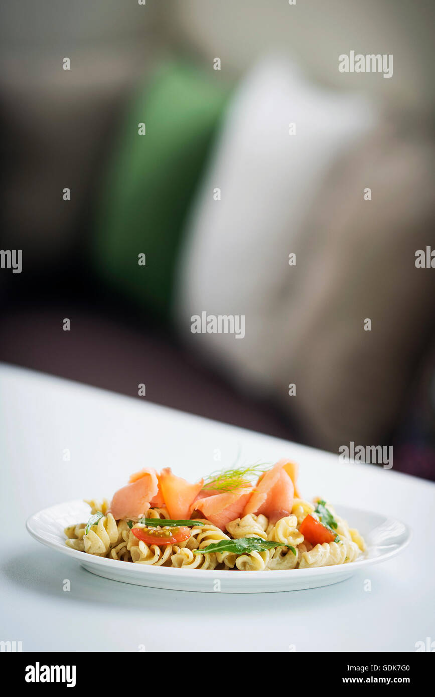 smoked salmon organic tomato and basil fresh pasta salad with ricotta cream sauce and dill Stock Photo