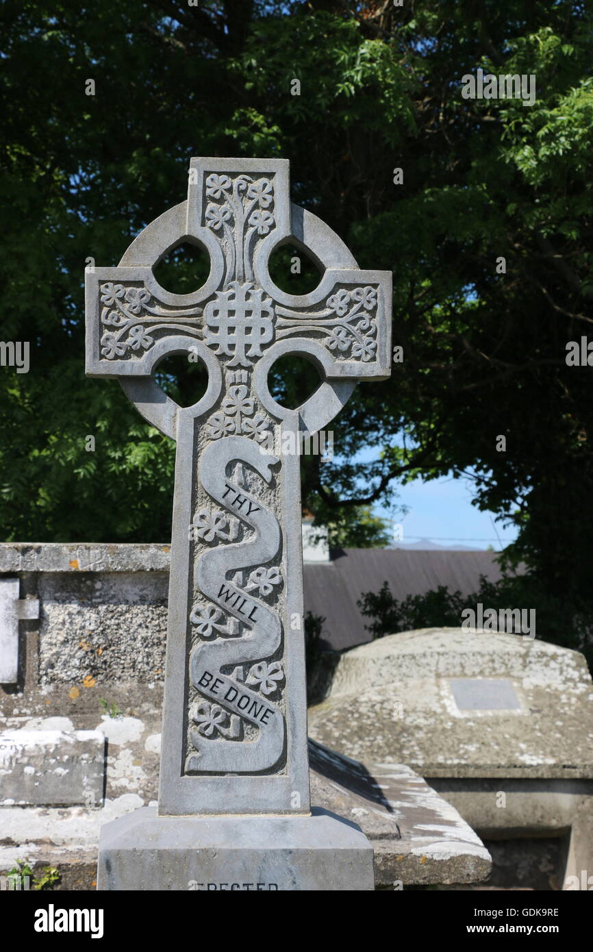 Thy Will be Done is inscribed on an ornate Celtic cross in a graveyard, Dingle Peninsula, Ireland. Stock Photo