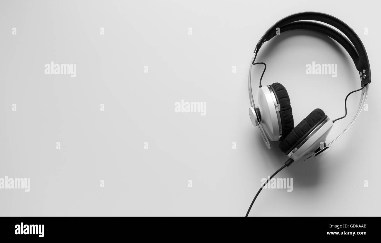 Single headphones on a table. Stock Photo