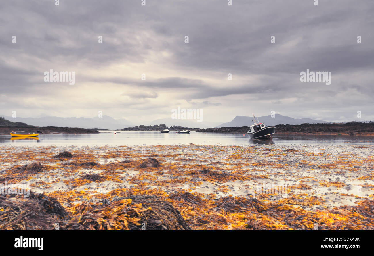 Low Tide Seaweed and Crab Fishing Boats, Southern End of the Sleat Peninsula, on the Isle of Skye in Scotland Stock Photo