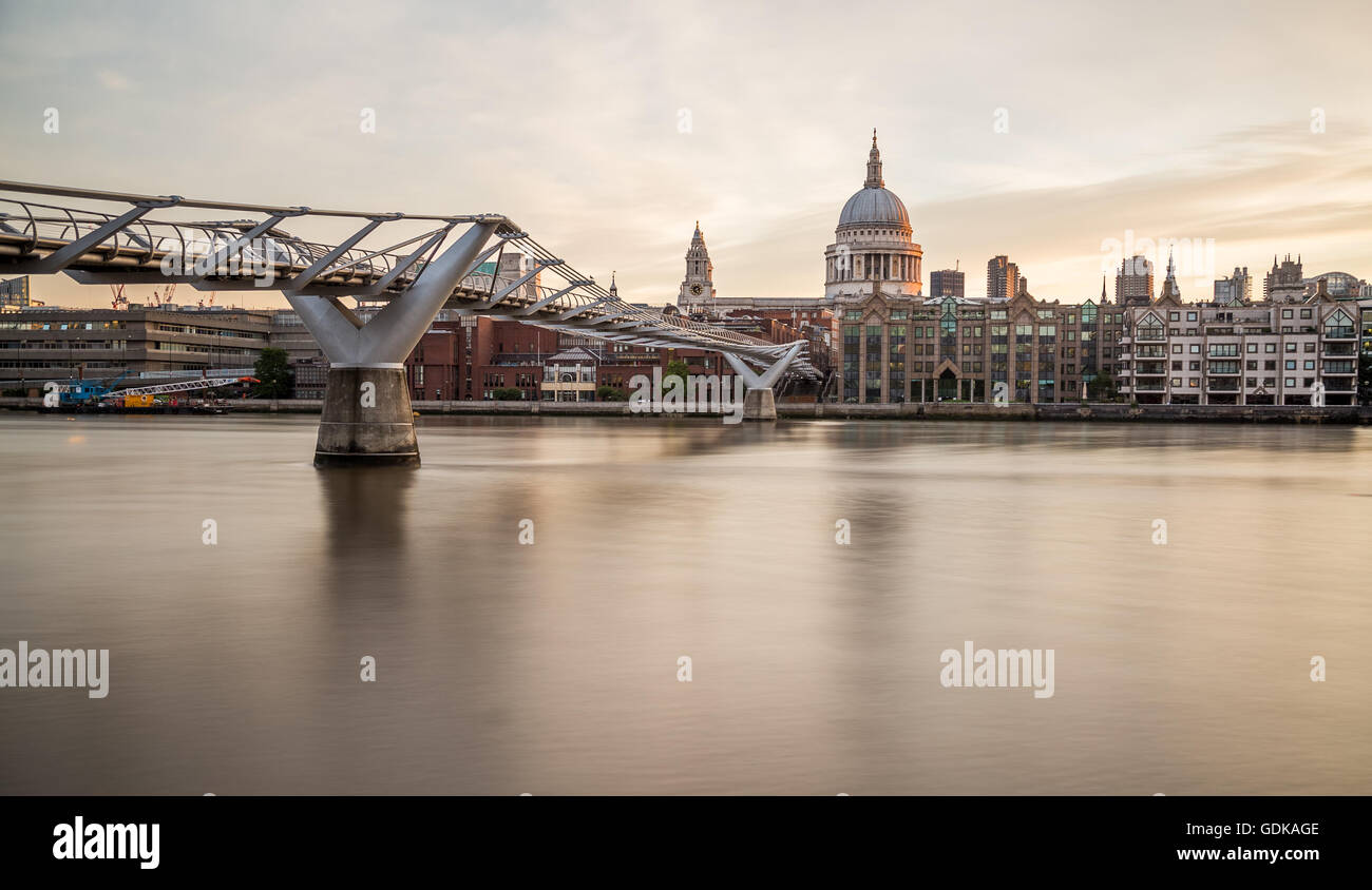 St Pauls Cathedral and Millenium Bridge in the morning from across the River Thames Stock Photo