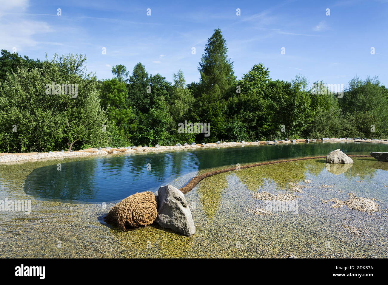 Natural swimming pond purifying water without chemicals through filters and plants Stock Photo