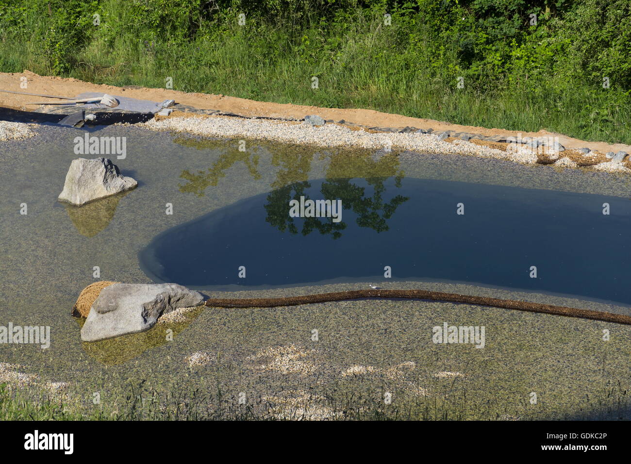Natural swimming pond purifying water without chemicals through filters and plants Stock Photo