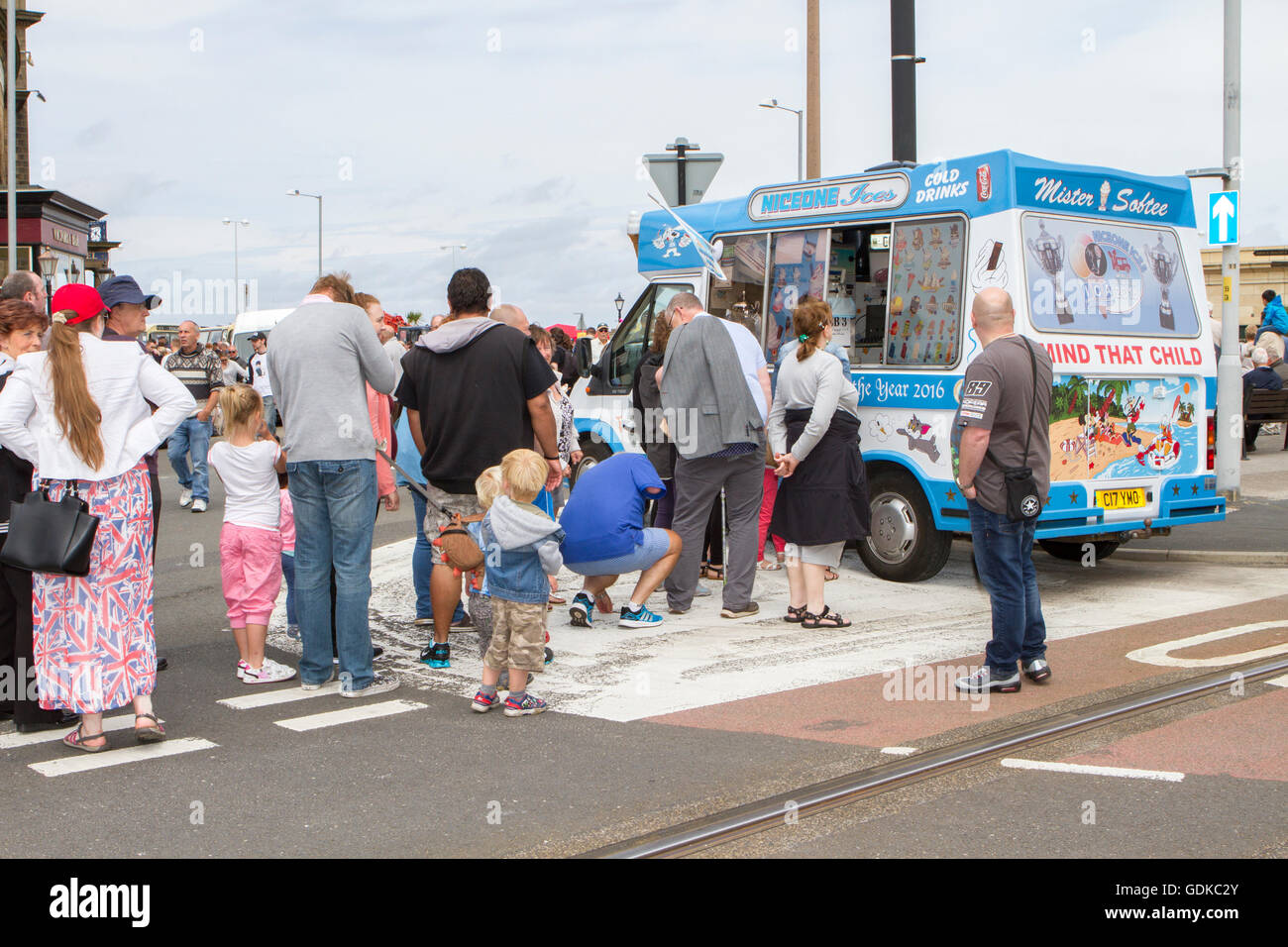 People queue queuing ice cream truck van sell seller vendor ice lolly lollies summers day hot mr whippy flake cool cold refreshing Stock Photo