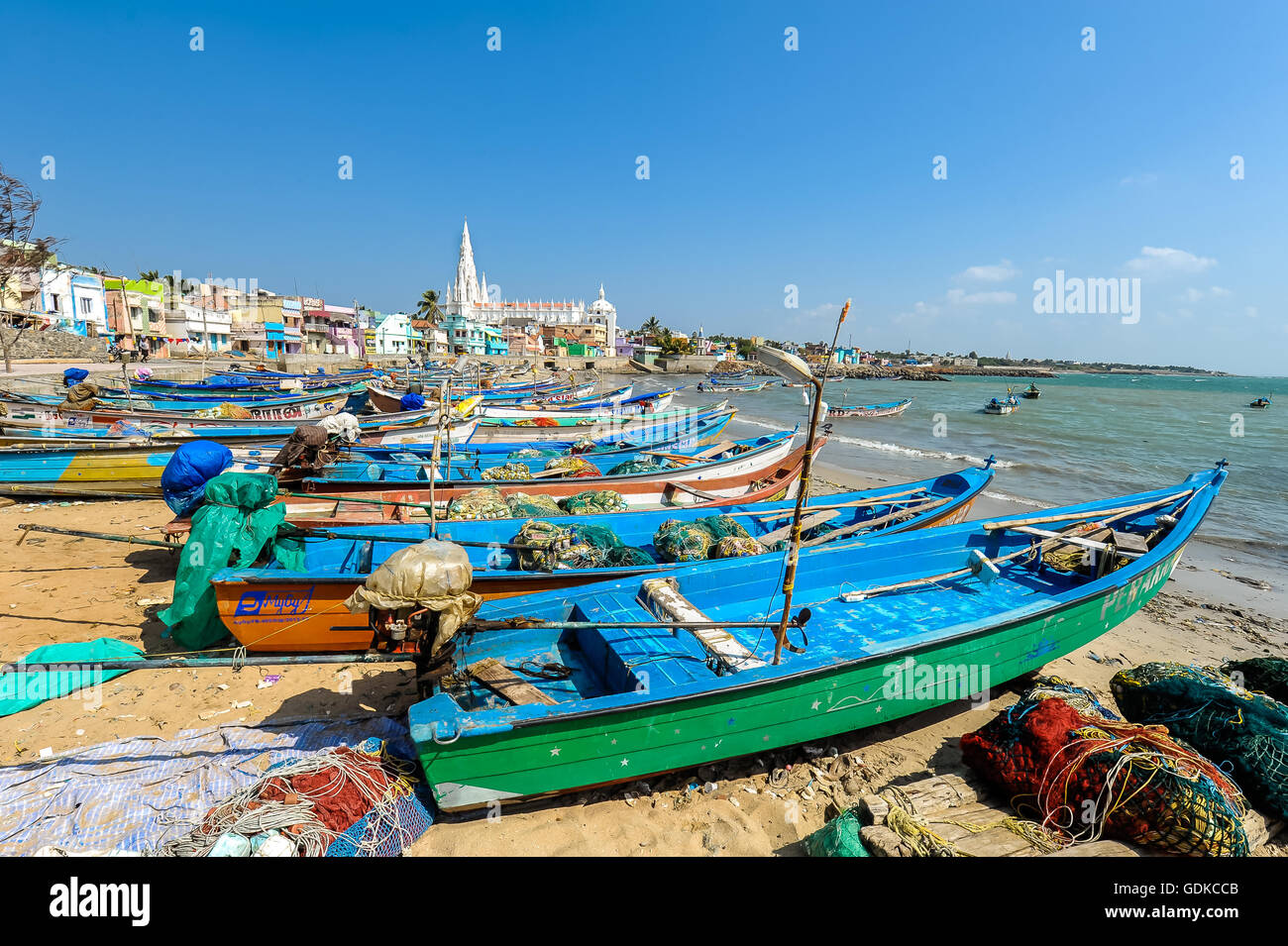 Colourful fishing boats in port, in the back pilgrimage church Our Lady of Ransom, Kanyakumari, Tamil Nadu, South India, India Stock Photo