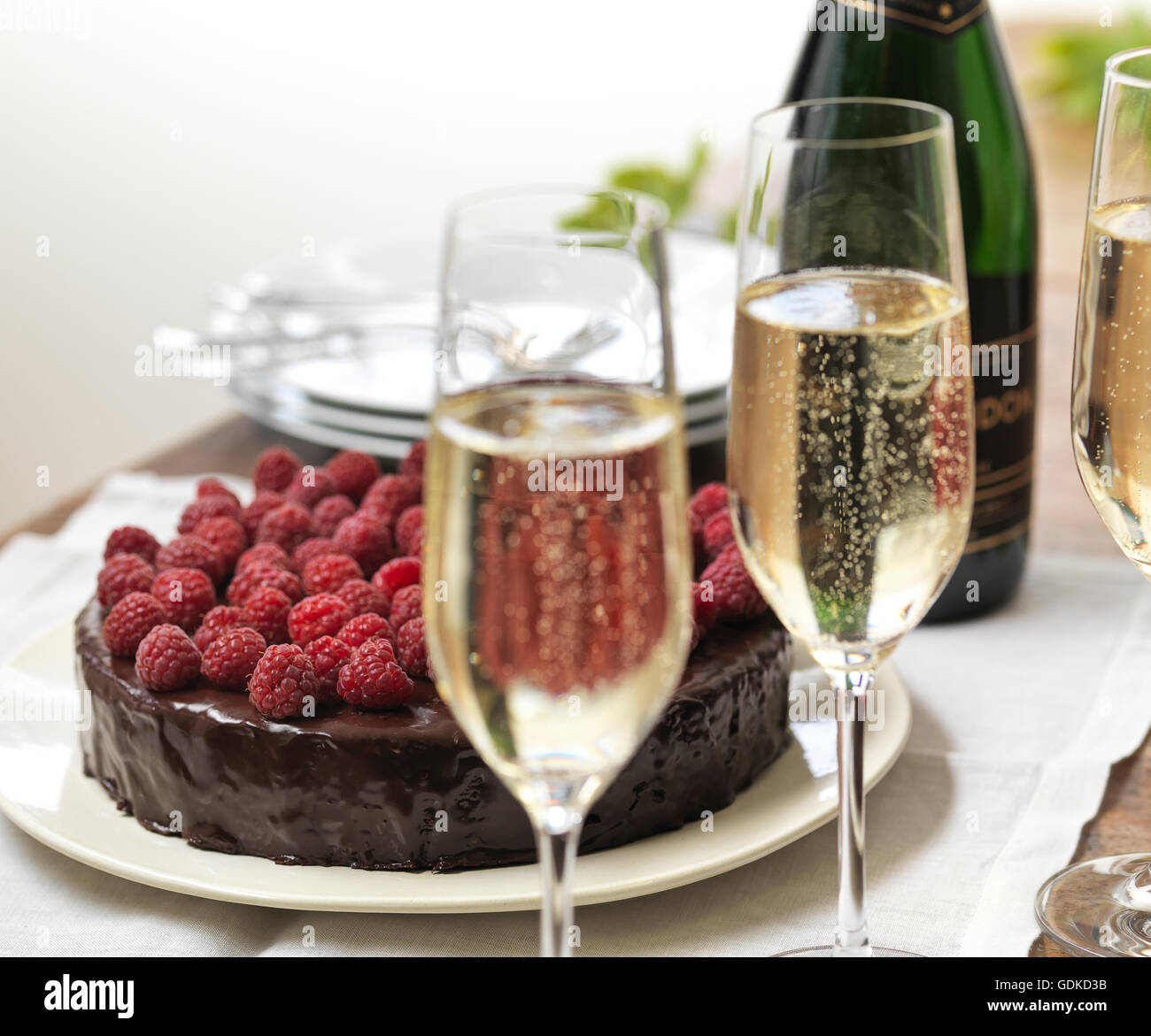 Raspberry chocolate cake with sparkling wine. Stock Photo