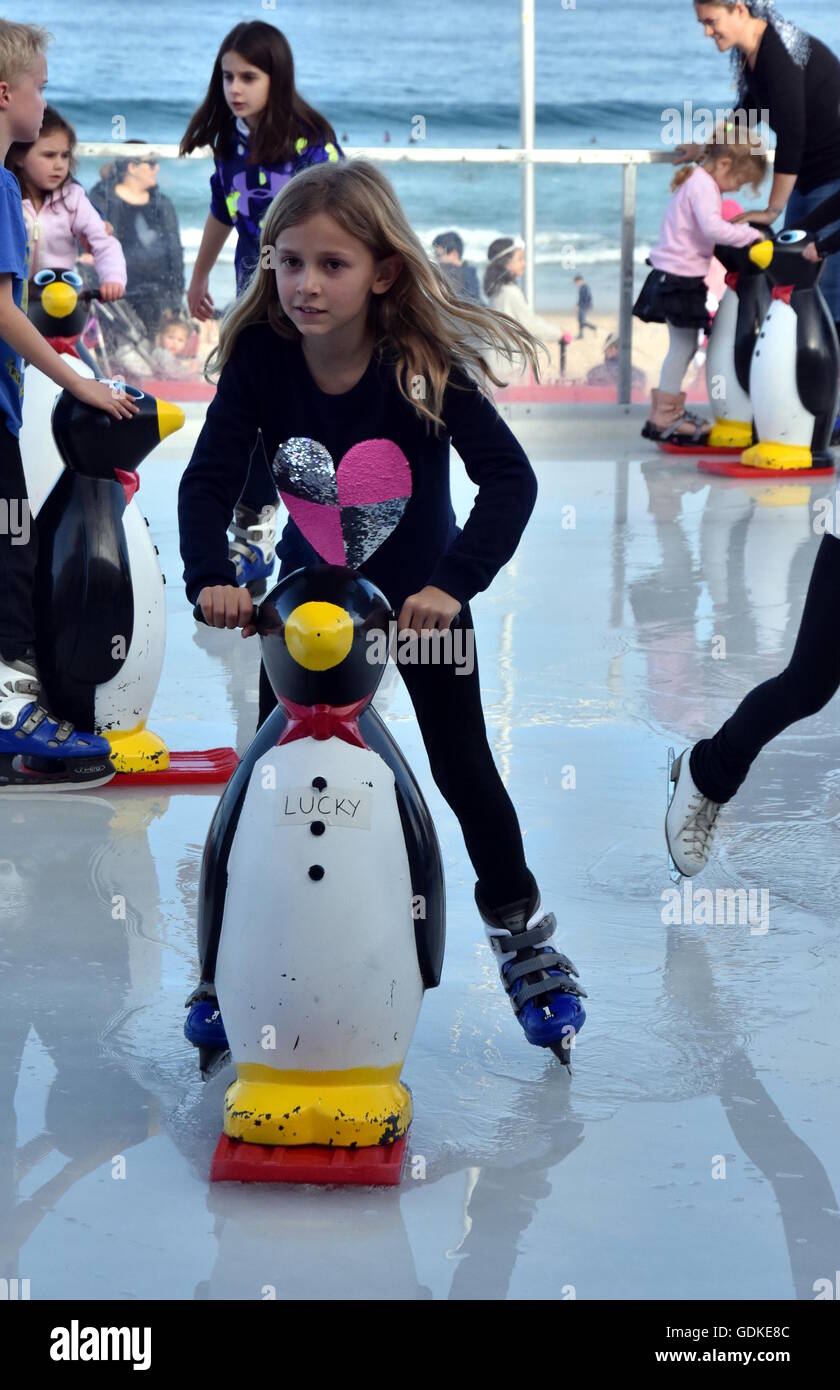Sydney, Australia Jul 17, 2016. A girl ice skating with a Penguin