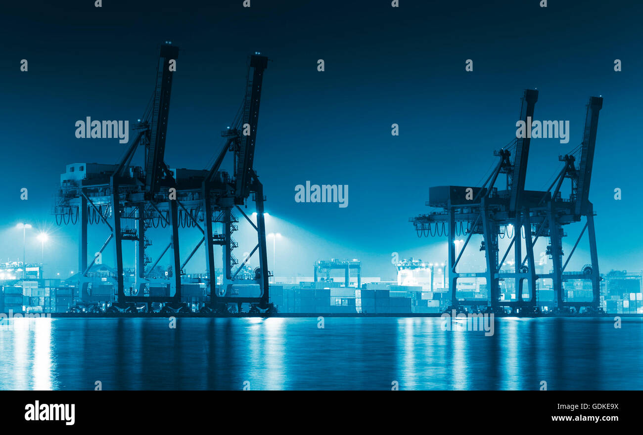 Container Cargo freight ship with working crane bridge in shipyard at ...