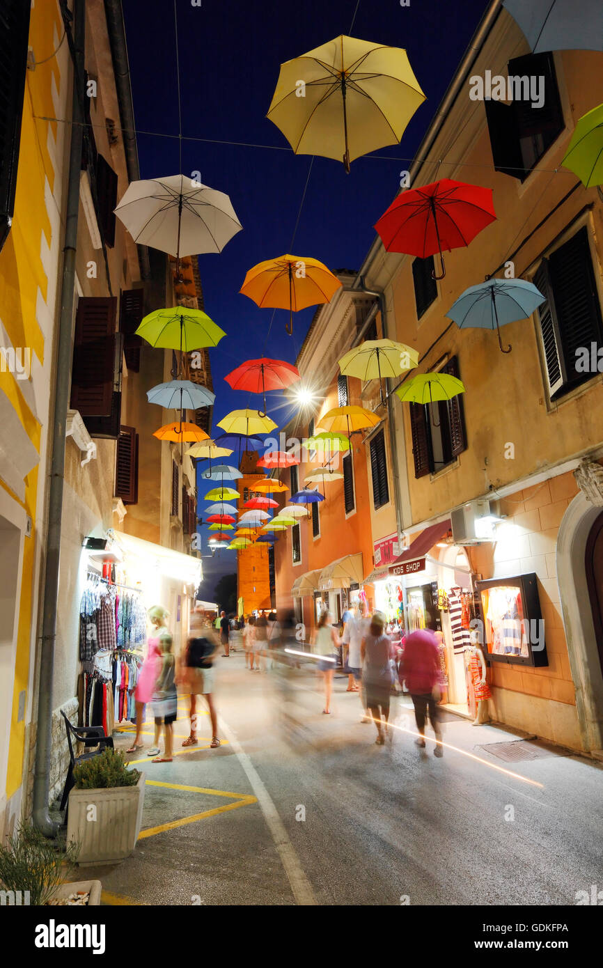 Open umbrellas hanging from strings in the street of Novigrad Stock Photo