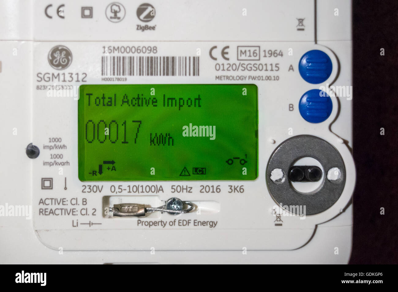 A newly installed EDF GE SGM1312 LCD display smart electricity meter showing reading of 17kWh in a wine cellar in London England Stock Photo