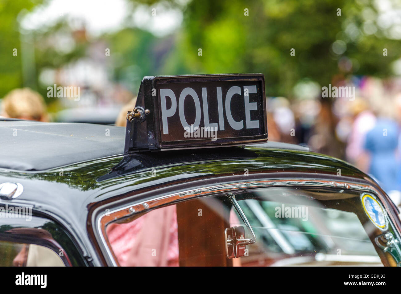 Police sign on the roof of an old black car car Stock Photo