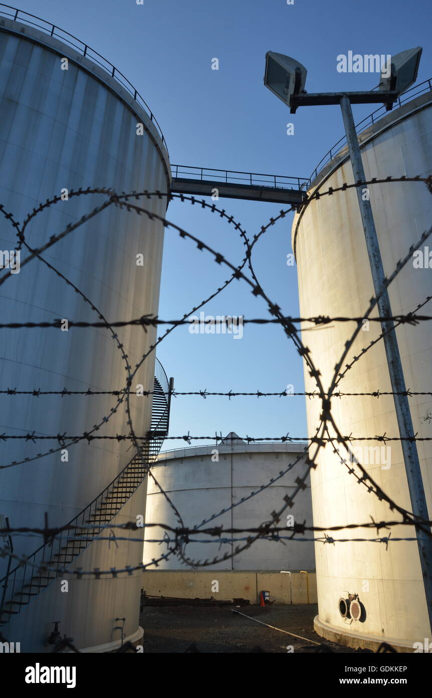 Oil storage tanks, barbed wire, fence, protected, oil, fuel, tank, outdoor, steel, liquid, pipelines, engineering, source Stock Photo