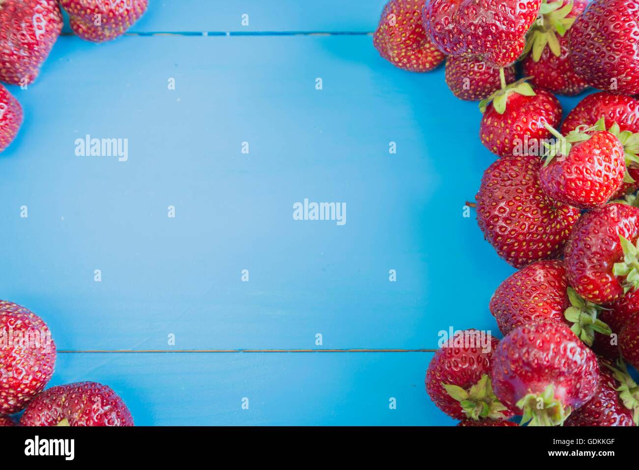 Fresh strawberries on blue background Stock Photo - Alamy