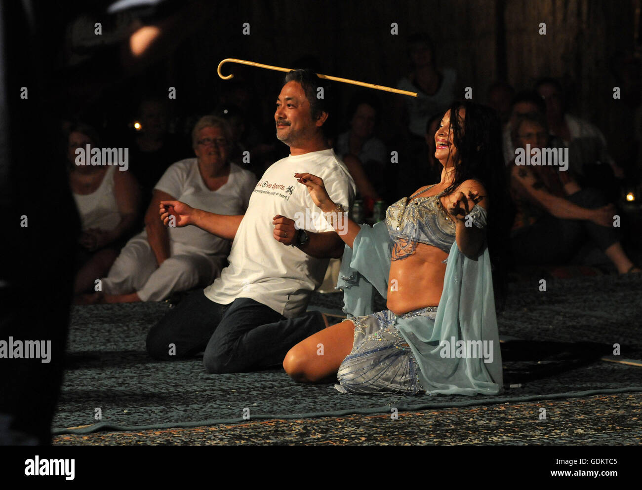 A belly dancer and a guest perform together, Dubai, UAE. Stock Photo