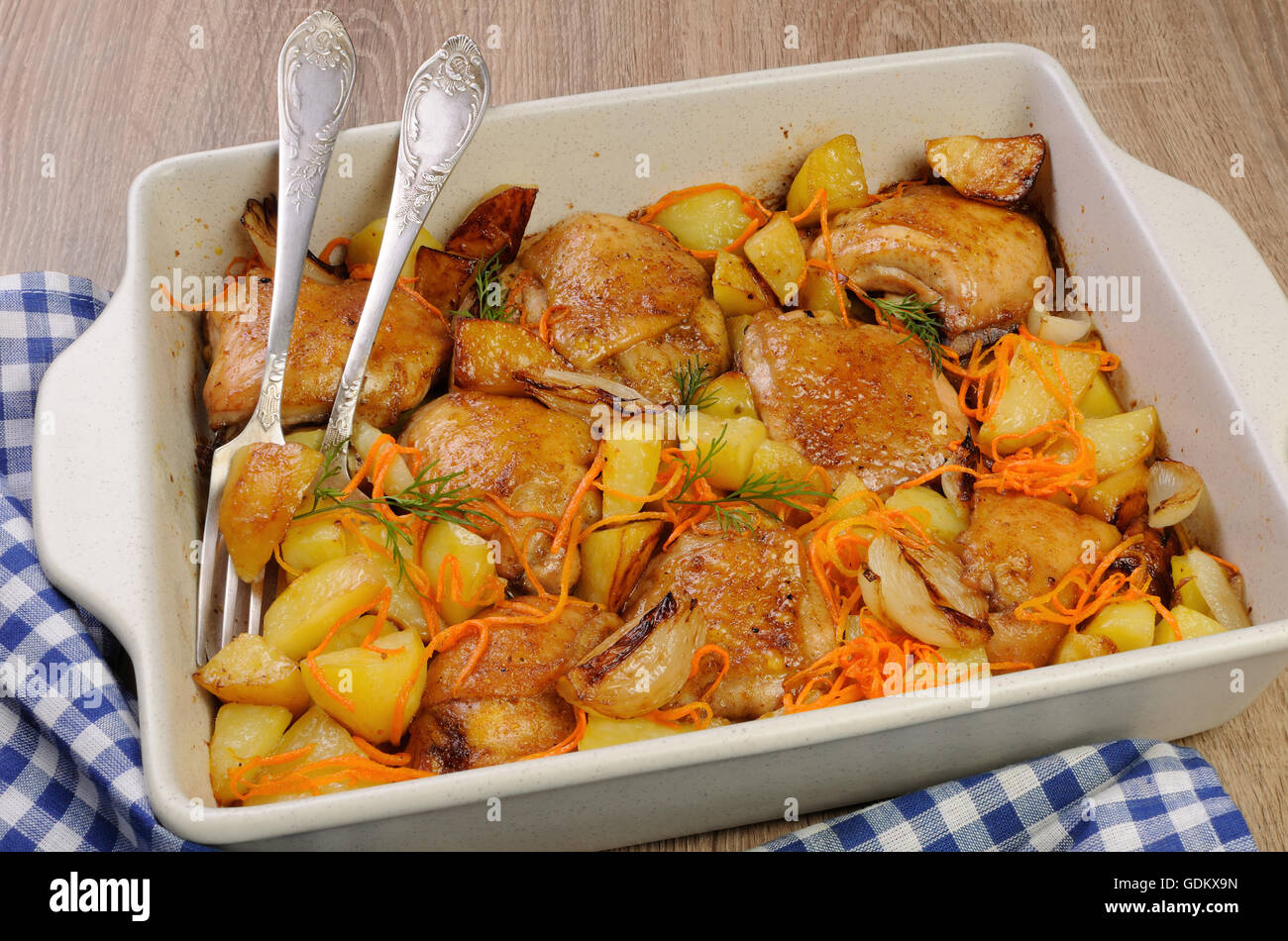 Braised roast chicken and vegetables in ceramic roasting pan Stock