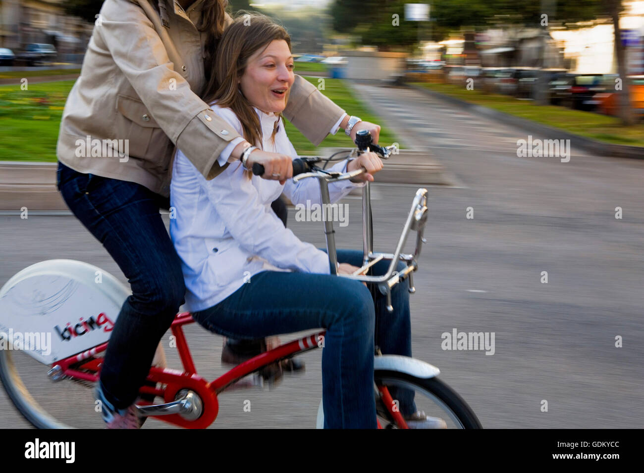 Barcelona: Two friends riding bike. In Diagonal Avenue Stock Photo