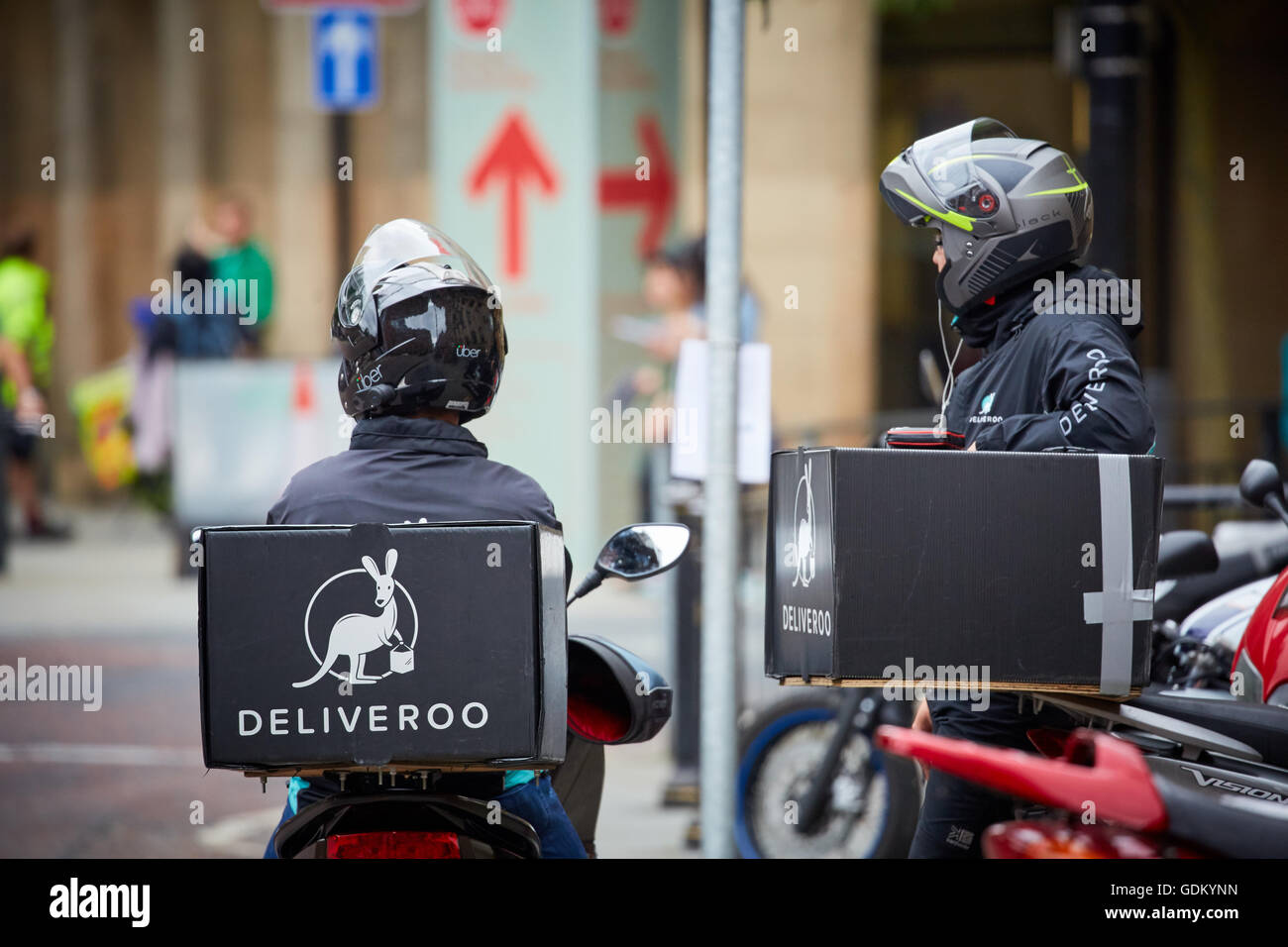 Deliver restaurant delivery service   Motorbike courier driver delivery deliveries waiting resting between drops take away food Stock Photo
