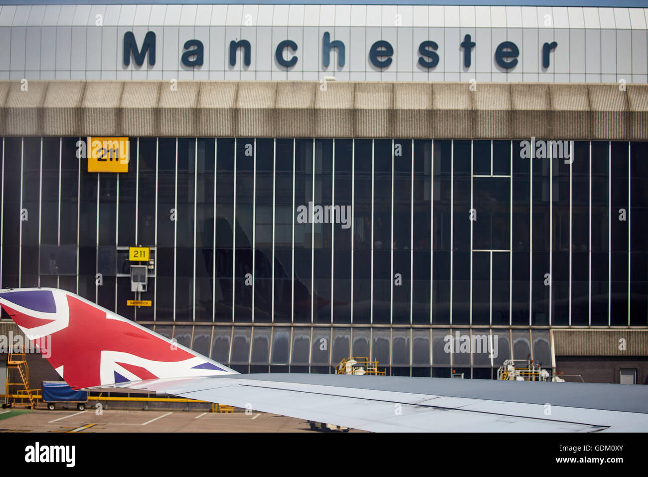 Ring way Manchester Airport T2 terminal from Virgin Atlantic 474 wingtip and Union Jack flag Stock Photo