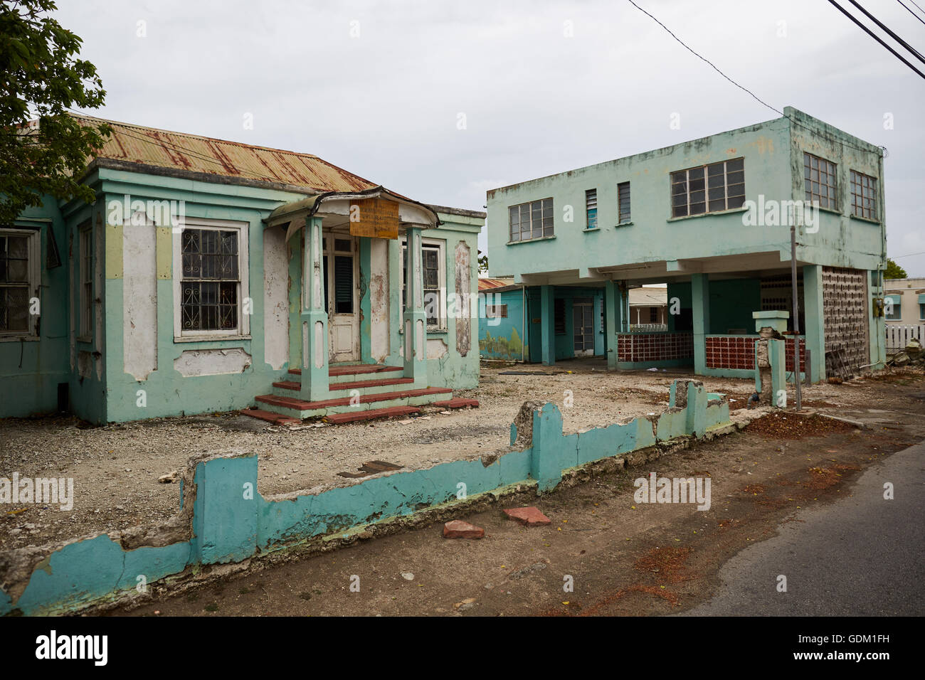 Abandoned taxi office Barbados Caribbean run down derelict urban mess empty disused scruffy building exterior green Stock Photo