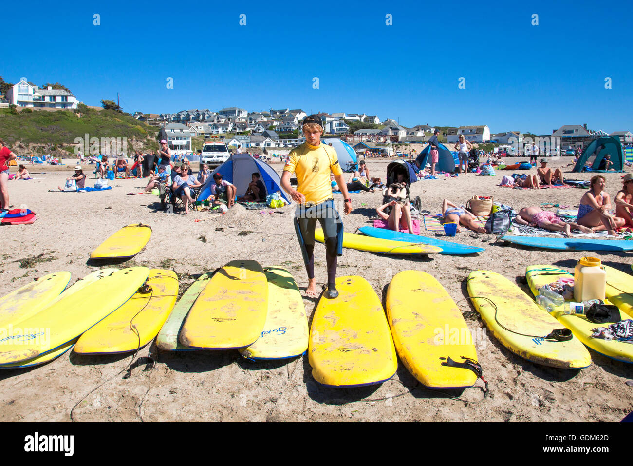 Polzeath, Cornwall, U.K. 18th July 2016. Surfers and families flock to the beach on a hot and sunny day in Cornwall. Situated on North Cornwall's Atlantic coast,  Polzeath is a popular location for surfers. Credit:  Mark Richardson/17�Թ����� Live News Stock Photo