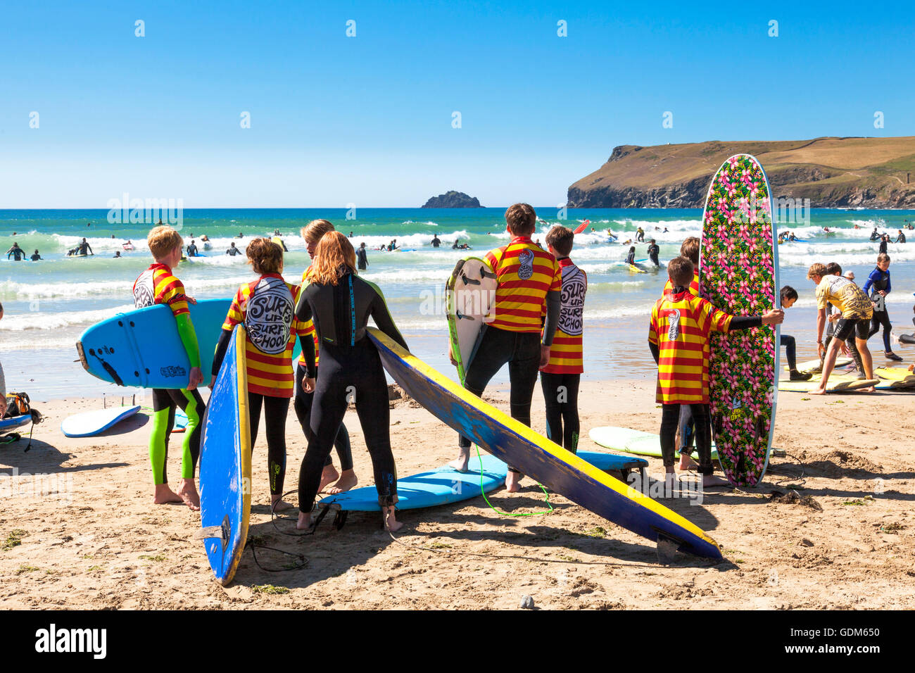Polzeath, Cornwall, U.K. 18th July 2016. Surfers and families flock to the beach on a hot and sunny day in Cornwall. Situated on North Cornwall's Atlantic coast,  Polzeath is a popular location for surfers. Credit:  Mark Richardson/17�Թ����� Live News Stock Photo