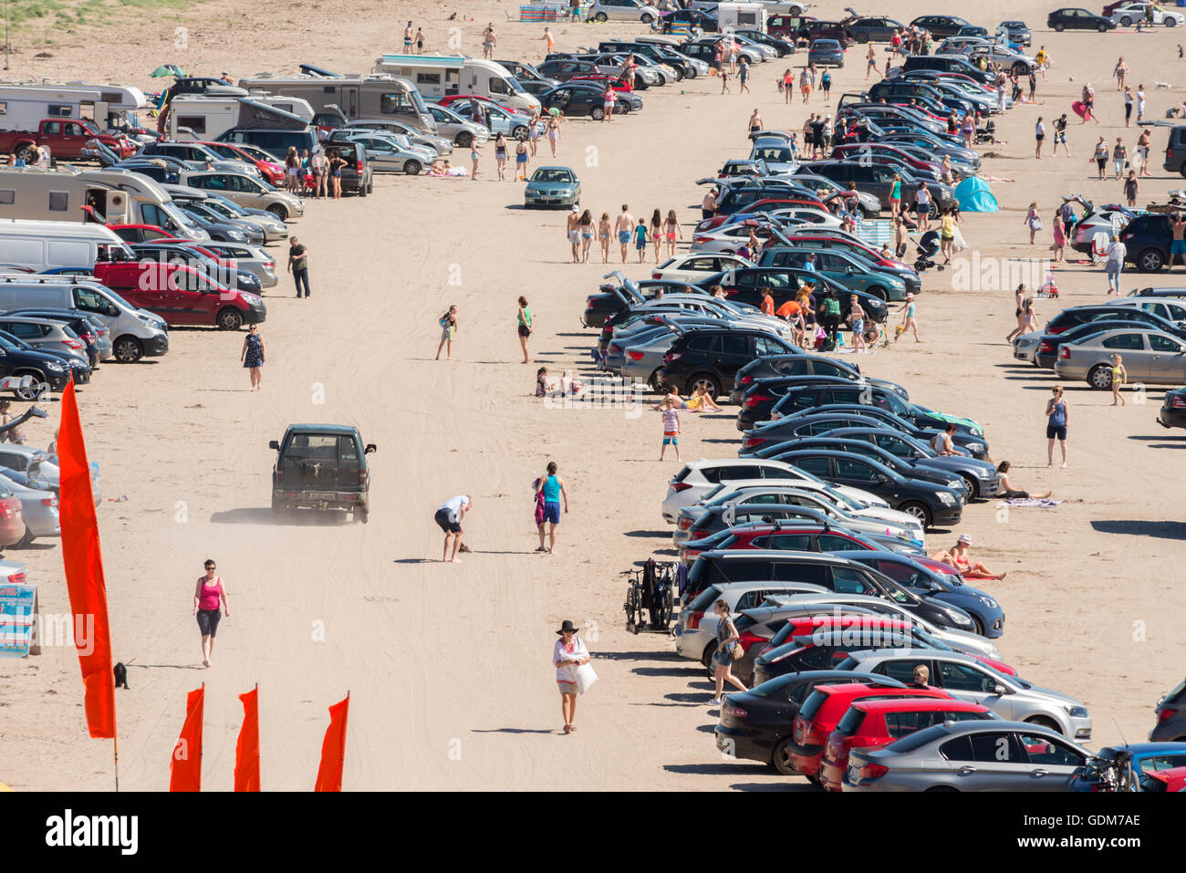 Sunny weather Ireland and Heatwave Ireland beach overhead view of people on sandy beach and numerous cars on crowded and packed Inch Beach located in County Kerry, Republic of Ireland as of 2016 Stock Photo